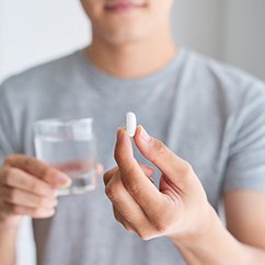 man holding pill in hand 
